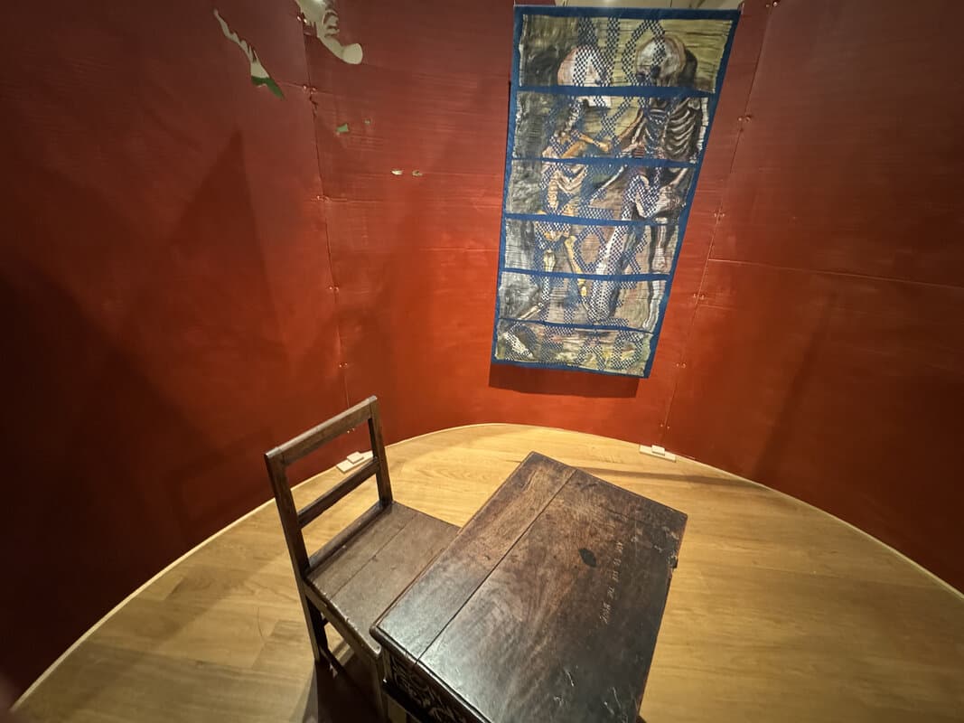 Espace d'installation avec murs rouges et œuvre en grille à la Whitechapel Gallery